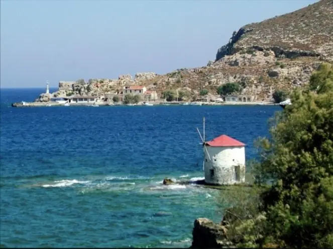 Un moulin à vent au bord de la mer turquoise